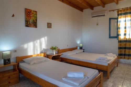 a room with two beds and a tv at Metochi Gavdos in Gavdos