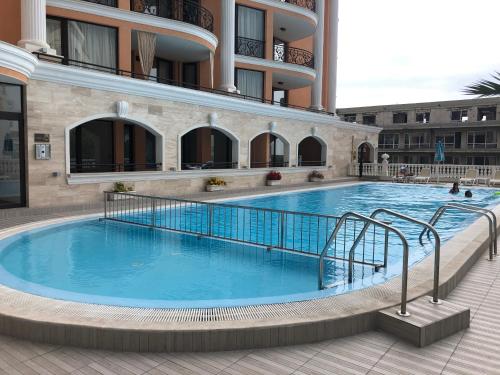 a large swimming pool in front of a building at Amazing apartment facing the sea in Burgas City