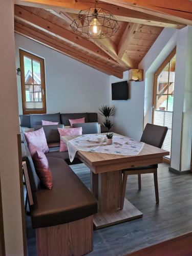 a living room with a wooden table and a couch at Ferienhaus Elisabeth in Forstau
