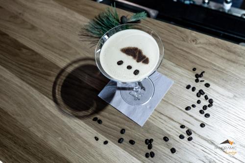 a martini glass on a table with a christmas ornament at Hotel Panoramic Lotsch in Sarntal
