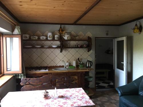 a living room with a table and a kitchen at Hotel Коттедж Leleka Vyzhnynsia in Rivna
