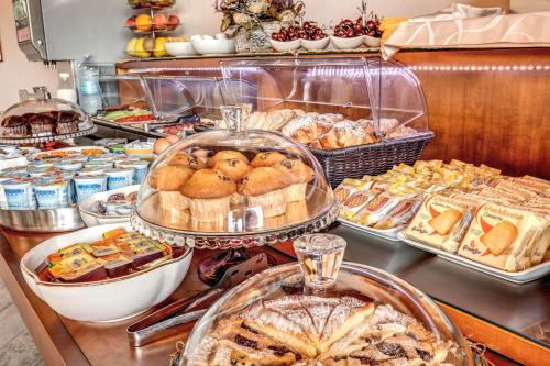 a buffet filled with different types of bread and pastries at Hotel Roma Tiburtina Metro in Rome