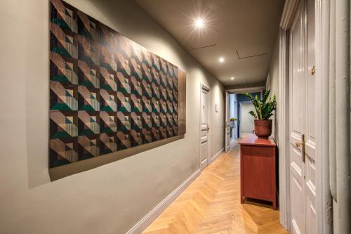 a hallway with a large painting on the wall at Glance in Rome in Rome