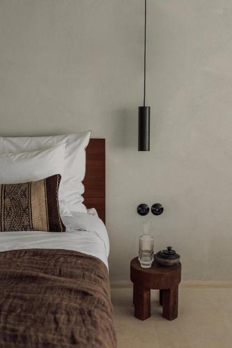 a bedroom with a bed and a table with a candle at OKU Ibiza in San Antonio