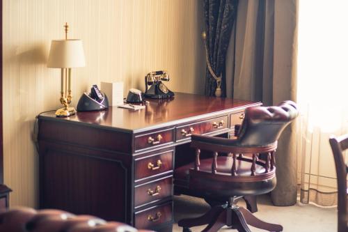 a telephone sitting on top of a desk with a chair at Hotel Devín in Bratislava