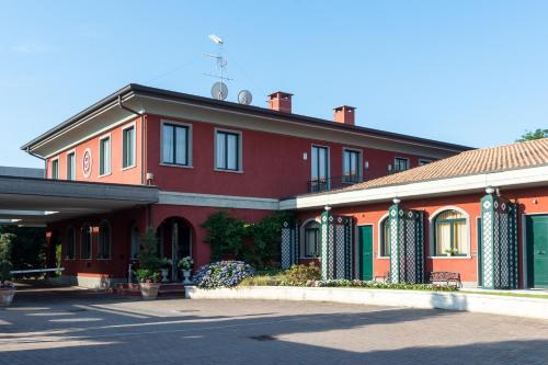 a red building with green and orange at Hotel Silver Milano in Milan