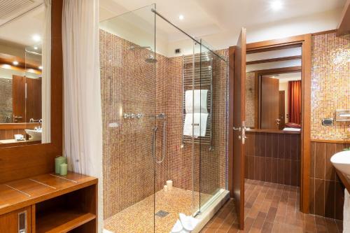 a bathroom with a glass shower and a sink at Hotel Silver Milano in Milan
