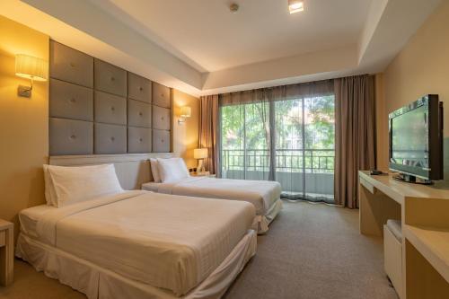 Un pat sau paturi într-o cameră la Oun Hotel Bangkok