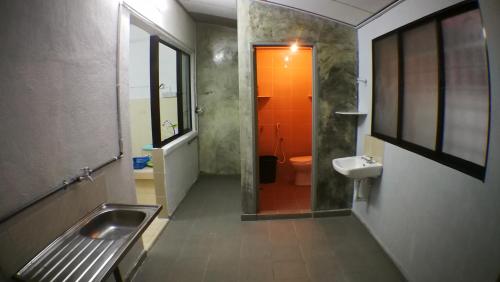 a bathroom with a sink and a toilet and a mirror at Josh's garage 2.0 Lost World Tambun for 8-10pax in Ipoh