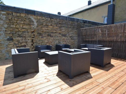 a row ofools on a deck with a brick wall at Holiday Home with bubble bath opened from 1 2 May to end of September in Florenville