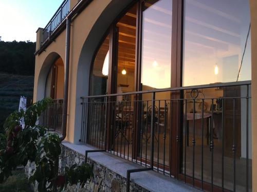 a balcony of a house with a sunset in the background at Agriturismo LaValleggia in Tovo San Giacomo