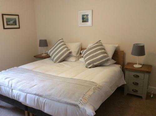 a bedroom with a bed with two pillows on it at Brandoch Lodge in Logierait