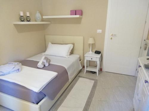 two beds in a small room with a door at Your House Rooms in Genova