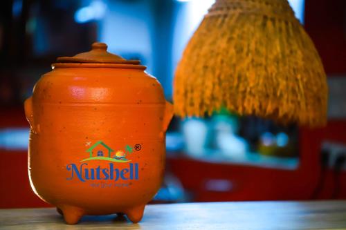 an orange pot sitting on top of a table at Nutshell-Airport Retreat by the Sea in Trivandrum