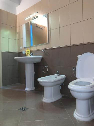 a bathroom with a toilet and a sink at Pearl Seaview Apartment in Vlorë