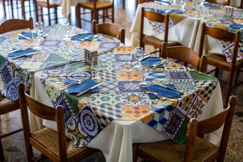 a table with plates and glasses on top at Madonna della Scala in Castellabate