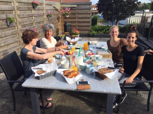 a group of people sitting around a table eating food at B&B 't Merthoes in Susteren