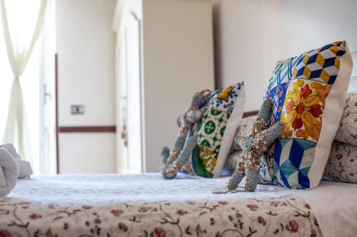 a room with a bed with pillows on it at Madonna della Scala in Castellabate