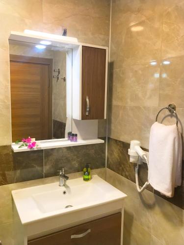 a bathroom with a sink and a mirror at Oliva Casa Datça in Datca
