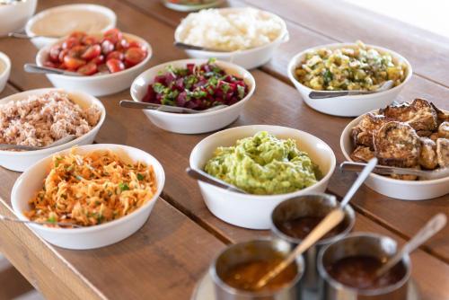 a table topped with bowls of different types of food at Nof Zuqim in Zuqim