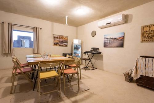 a room with a table and chairs and a refrigerator at Nof Zuqim in Zuqim