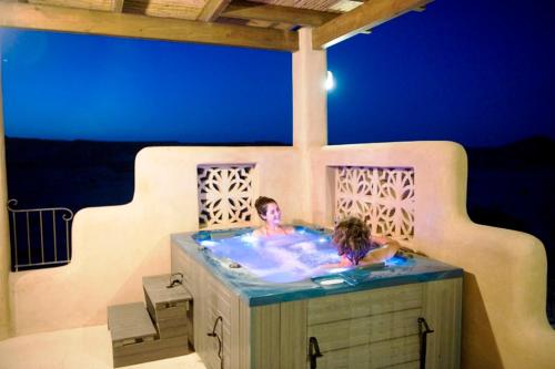 a man and a woman in a hot tub at Nof Zuqim in Zuqim