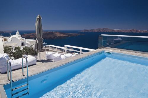 a swimming pool with a view of the ocean at Hotel Thireas in Fira