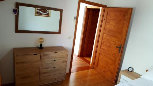 a bedroom with a wooden door and a wooden dresser at Apartment Korcula in Korčula