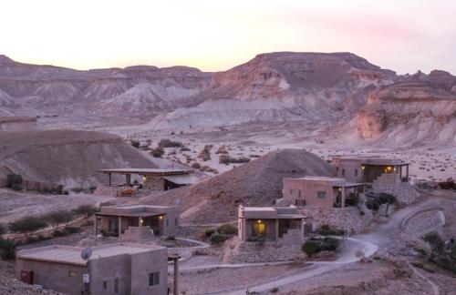a house in the desert with mountains in the background at Nof Zuqim in Zuqim