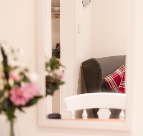 a reflection of a chair in a mirror at A Stay On The Brae in Edinburgh