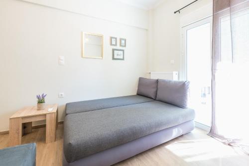 a bed in a room with a table and a window at Exeptional Apartment in Athens