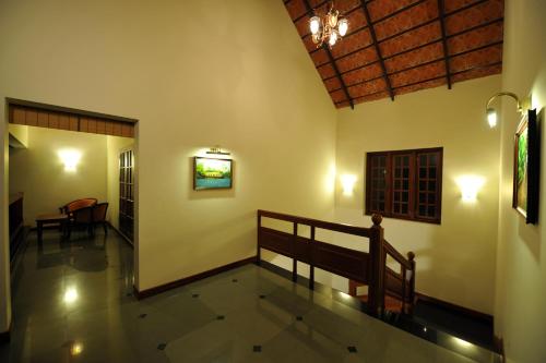 a hallway of a house with a chandelier at The Villa Romantica in Nedumbassery