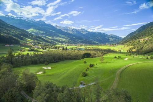 an aerial view of a golf course in the mountains at EUROPÄISCHER HOF Bad Gastein in Bad Gastein