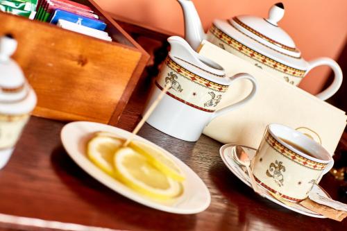 a table with cups and saucers on a table at Albergo Trattoria Il Leone in Pomponesco