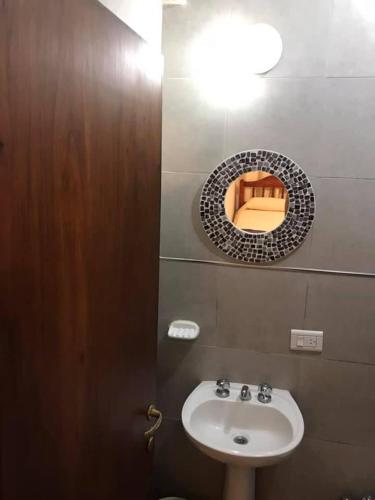 a bathroom with a sink and a mirror on the wall at Cerro del sol, habitaciones privadas in Salta
