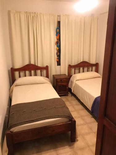 a bedroom with two beds and a window at Cerro del sol, habitaciones privadas in Salta