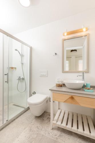 a bathroom with a toilet and a sink and a shower at Monza House Otel in Siğacık