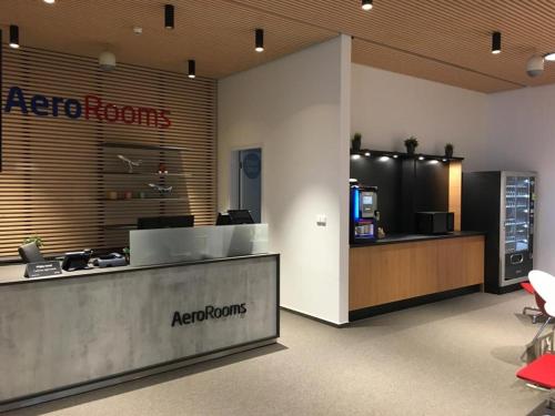 an office lobby with a reception desk and aazoptrons sign at AeroRooms in Prague