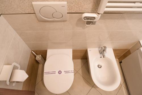 a bathroom with a toilet and a sink at Prestige Apartments by Quokka 360 - spacious flats with terraces in Lugano