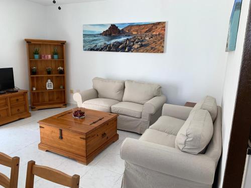 a living room with two couches and a coffee table at Casa Delores in Playa Blanca