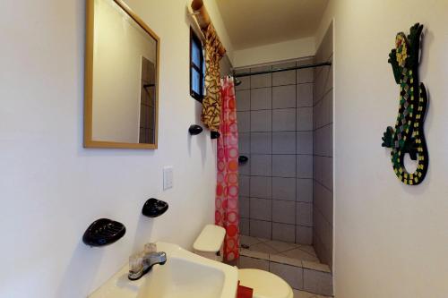 a bathroom with a sink and a shower at Mayan Falls in Caye Caulker