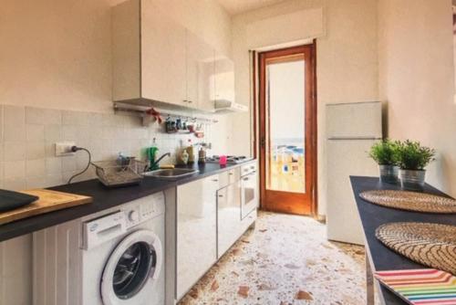 a kitchen with a washing machine and a refrigerator at Casa Liliana in Marsala