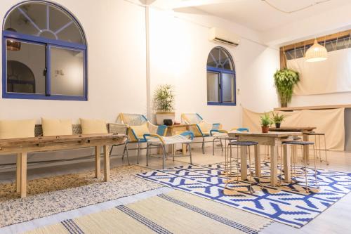 a room with tables and chairs and a rug at Island River in Green Island