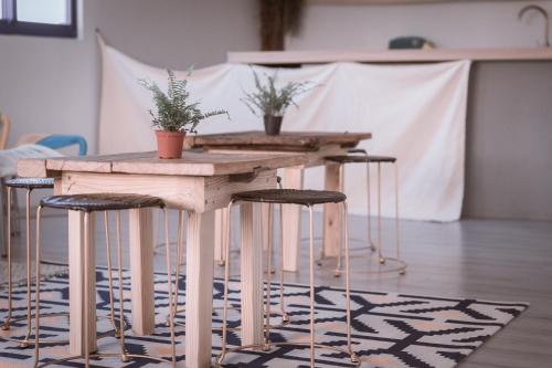 a wooden table with plants on top of a rug at Island River in Green Island