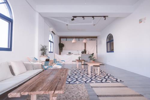 a living room with a couch and a table at Island River in Green Island