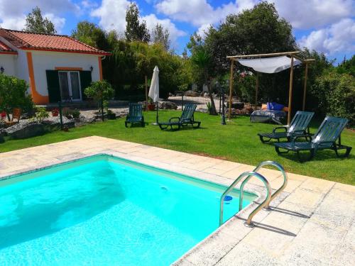 a swimming pool in the backyard of a house at Quinta Sao Martinho in Reguengo Grande
