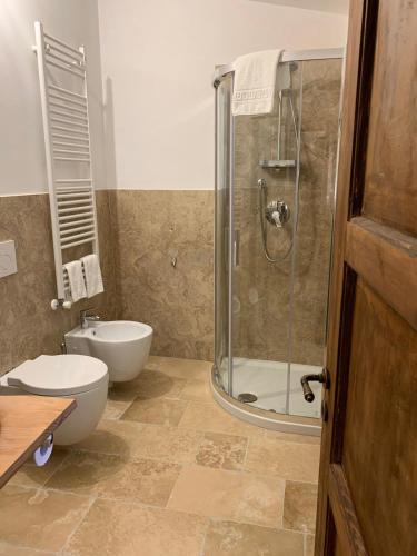 a bathroom with a toilet and a glass shower at Due forni affittacamere in Matera