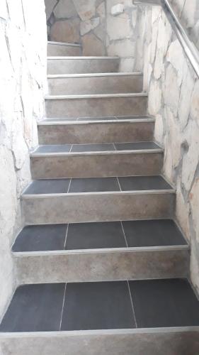 a set of concrete stairs with a stone wall at Ferienwohnung Petrovic in Krimovice