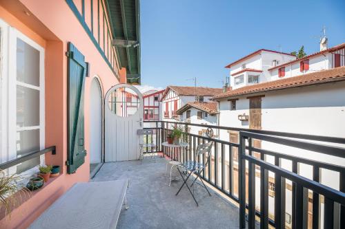 a balcony with a table and chairs on a building at Boutique hôtel Maria-Christina in Saint-Jean-de-Luz