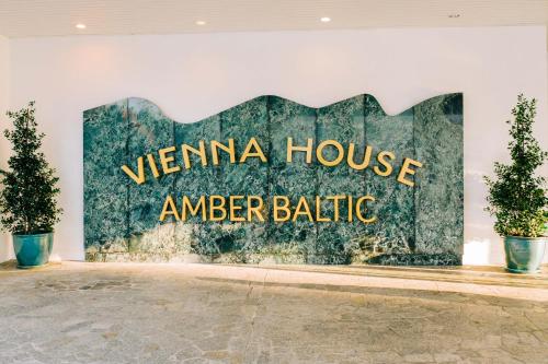 a sign that saysvenina house amiger battle on a wall at Vienna House by Wyndham Amber Baltic Miedzyzdroje in Międzyzdroje